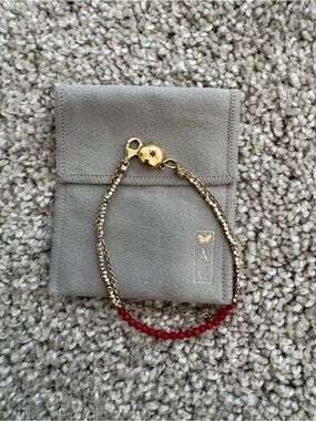 Gold-Tone Bracelet with Red Beads and Locket Charm